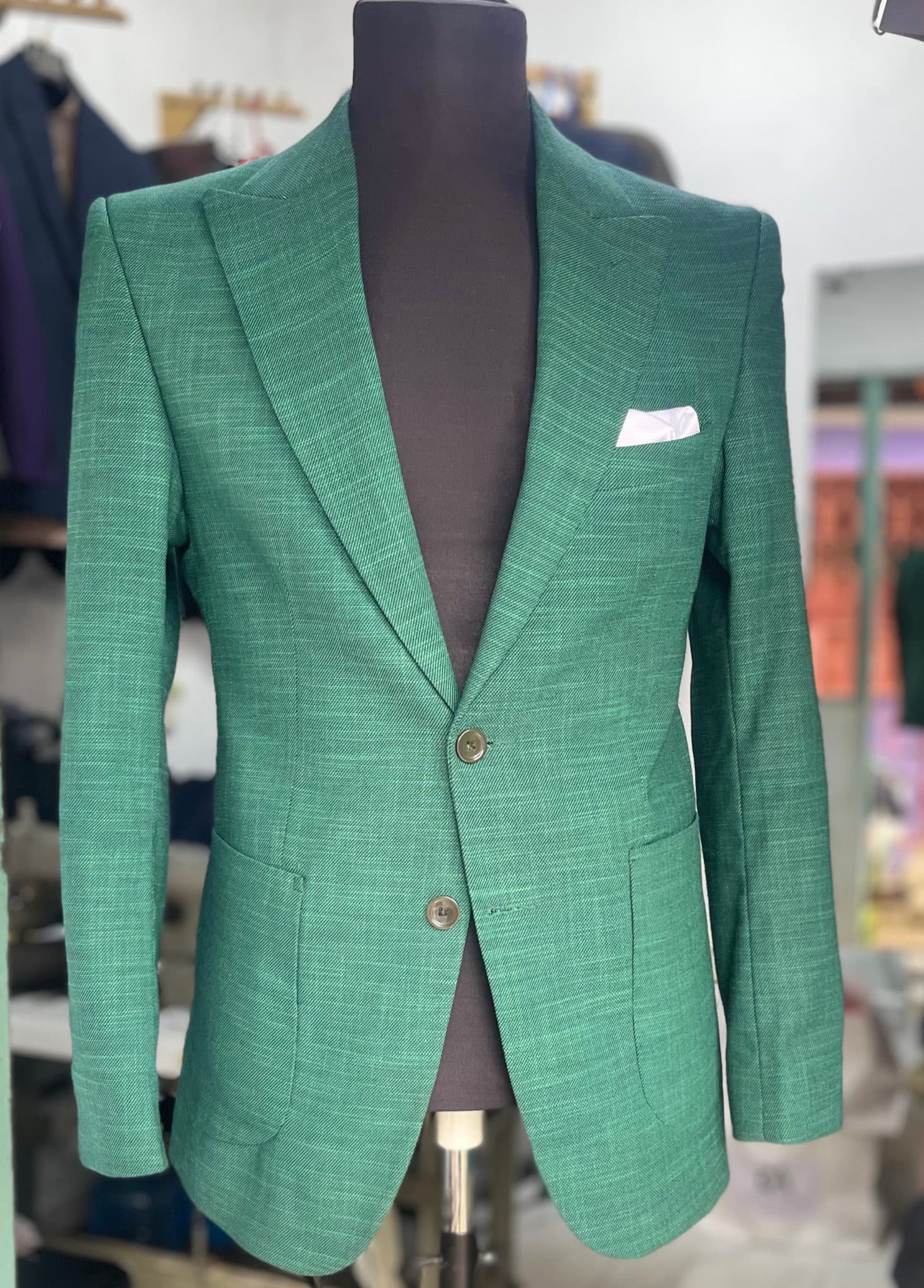 Green Dulo Attires tailored jacket on mannequin