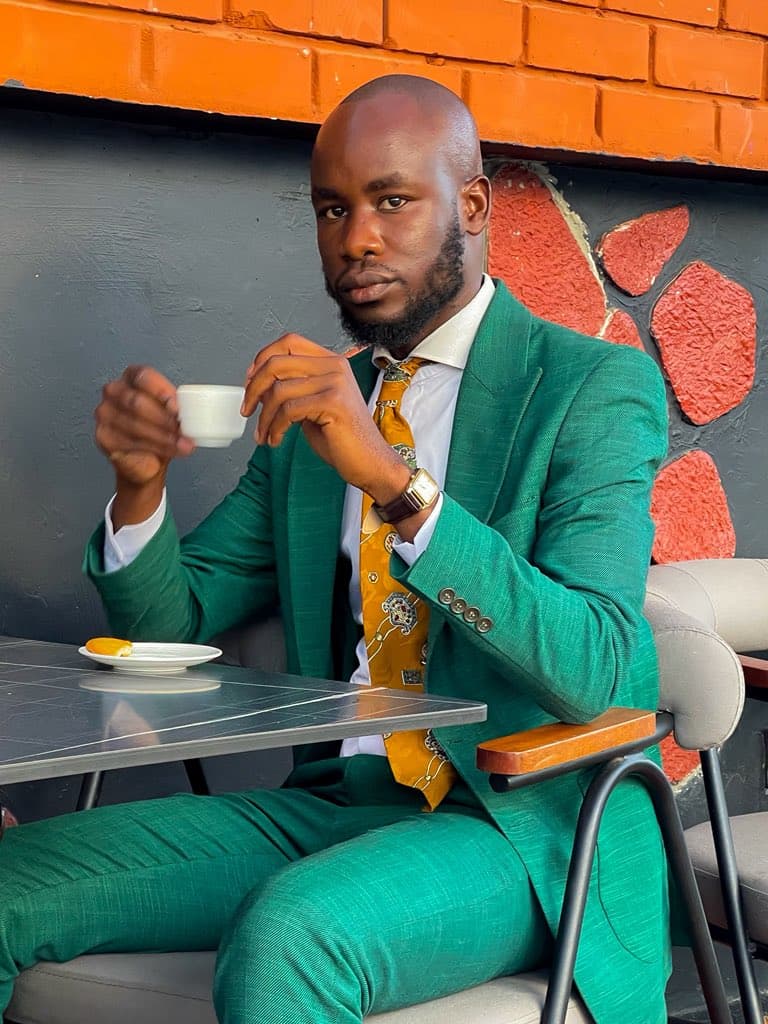 Dulo Attires green bespoke suit worn in a relaxed setting