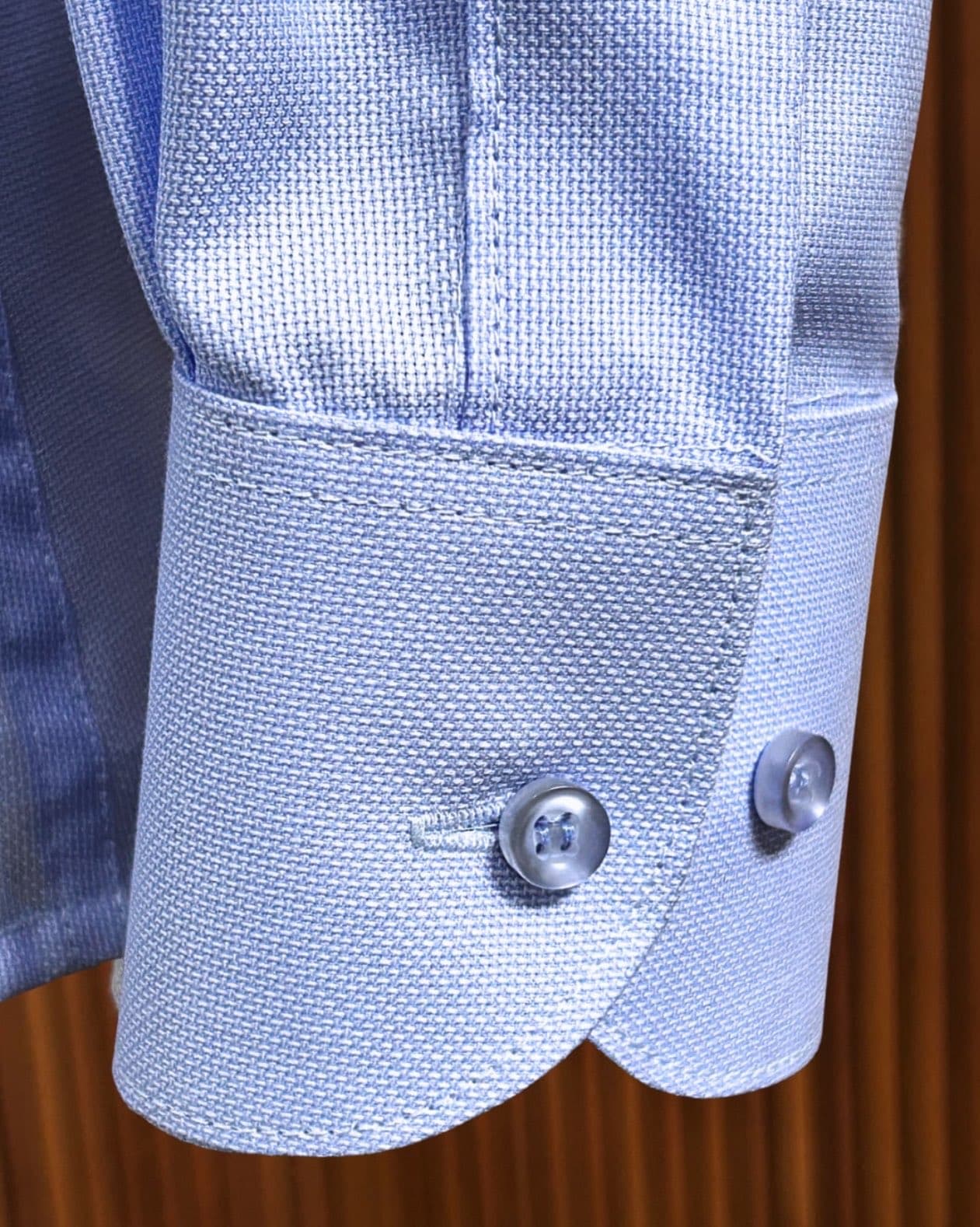 Close-up of a Dulo tailored cuff showing fabric texture, buttons and finishing