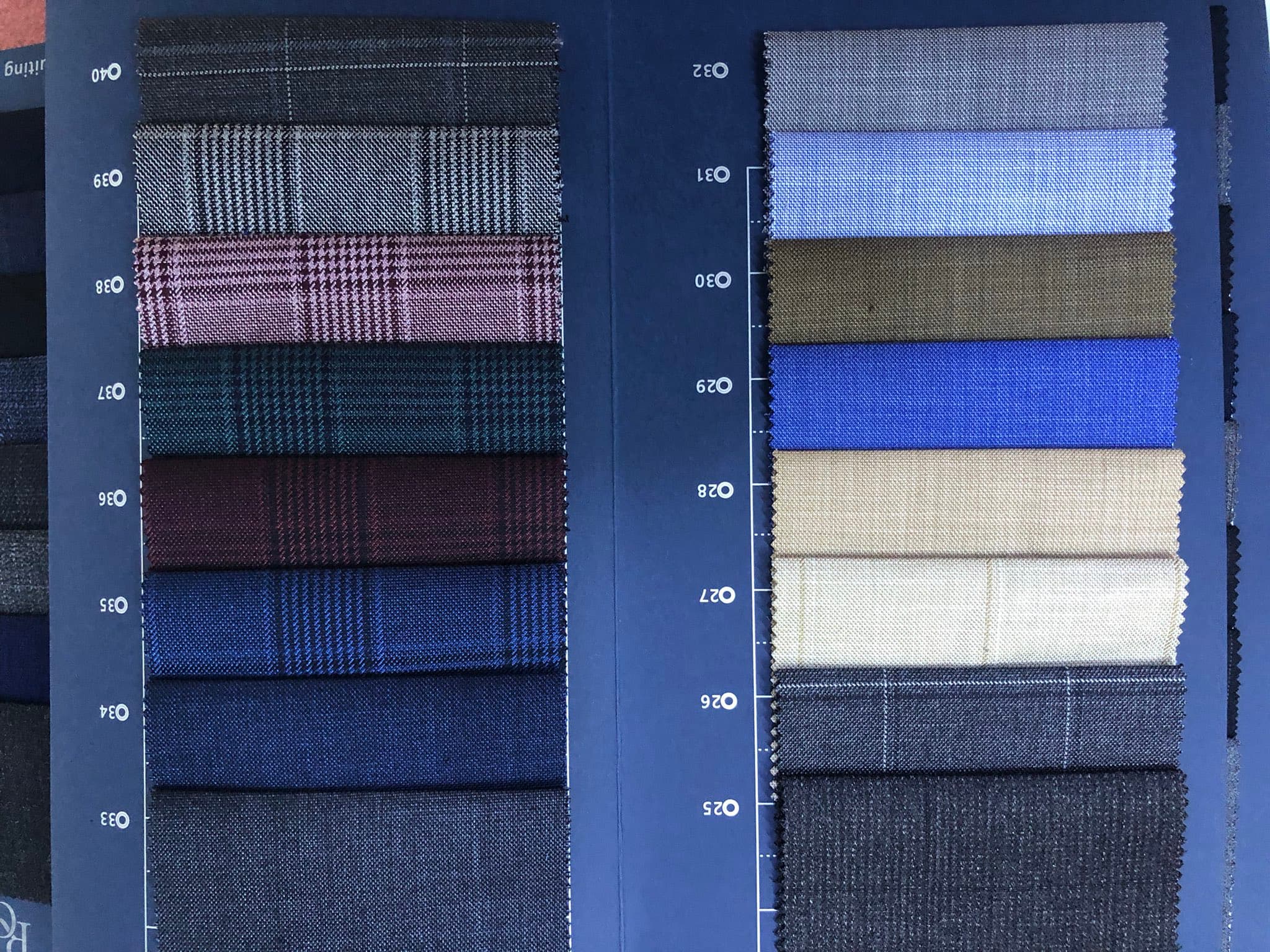 Dulo Attires fabric swatch book showing a selection of suiting cloth
