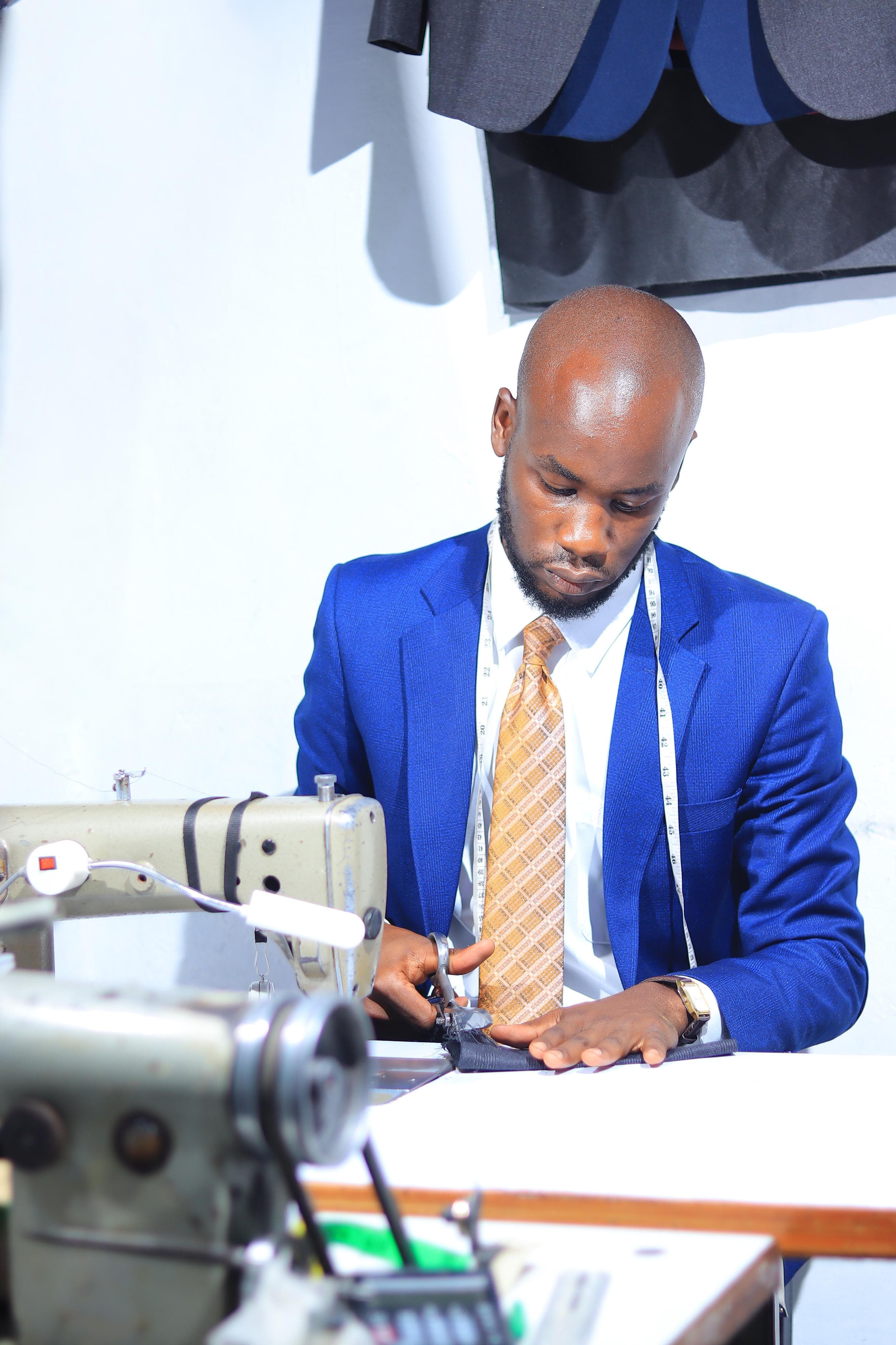 Bruce working at the sewing machine at Dulo Attires