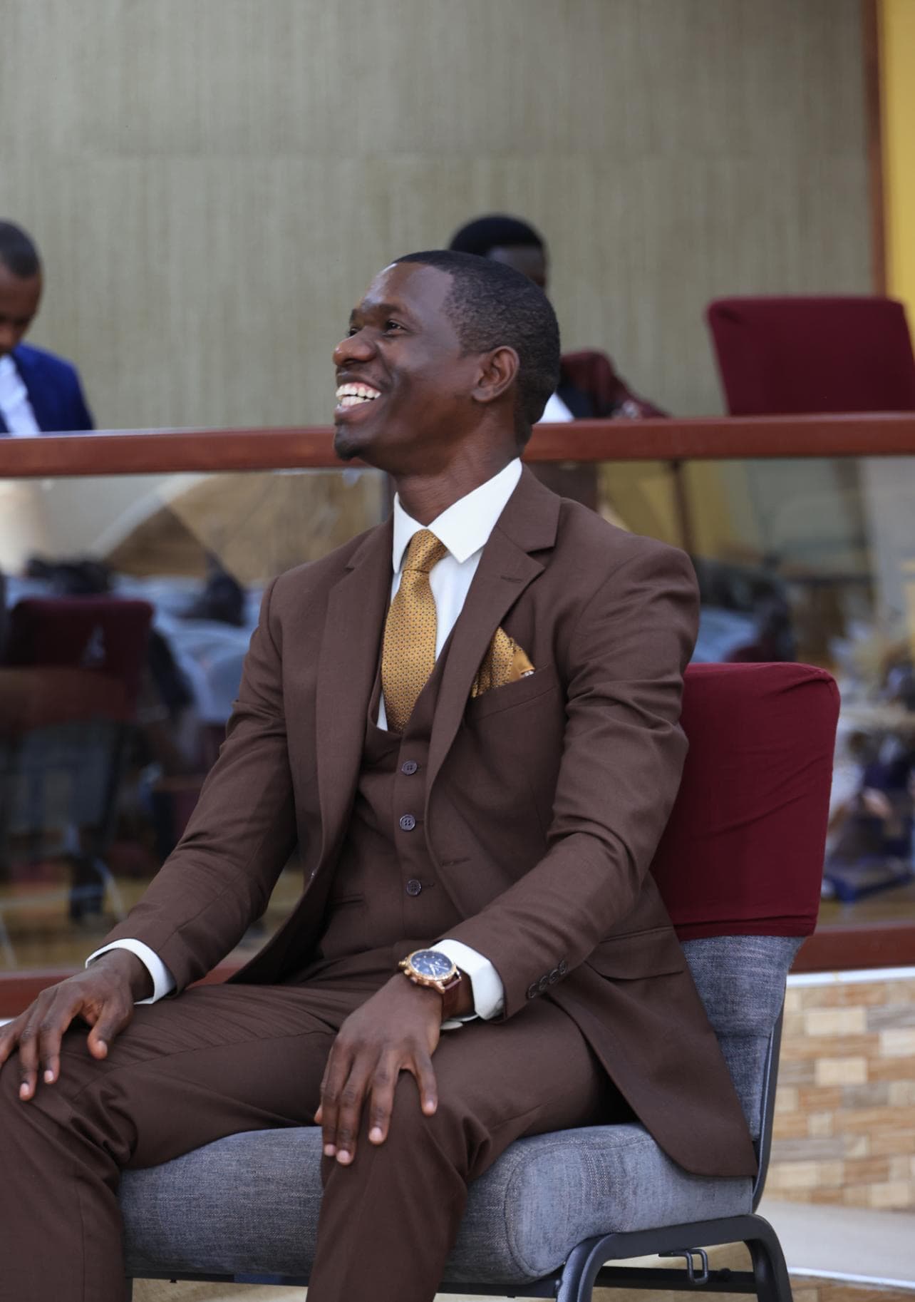 Brown three-piece bespoke suit by Dulo Attires